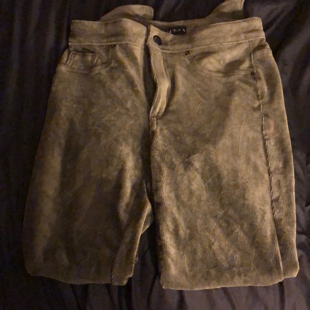 Olive green corduroy trousers.